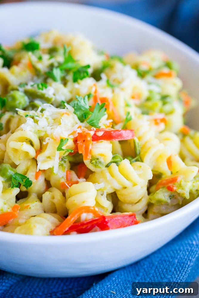 Quick One-Pot Primavera Pasta 4 Serving of Easy One-Pot Pasta Primavera in a bowl, garnished with fresh parsley, highlighting its appeal as a healthy and convenient meal.