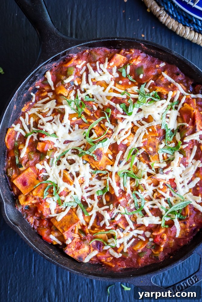One Pan 30 Minute Pizza Meal 4 Serving of 30-Minute Pizza Skillet Casserole with fresh basil, showcasing its cheesy, comforting appeal.