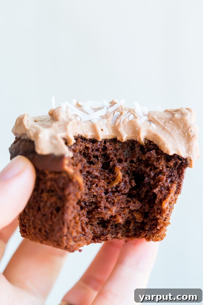 Decadent Vegan Gluten-Free Chocolate Coconut Cupcakes with Silky Chocolate Whipped Cream 4 Chocolate Coconut Cupcakes cooling on a wire rack, ready for the delicious Chocolate Whipped Cream frosting.