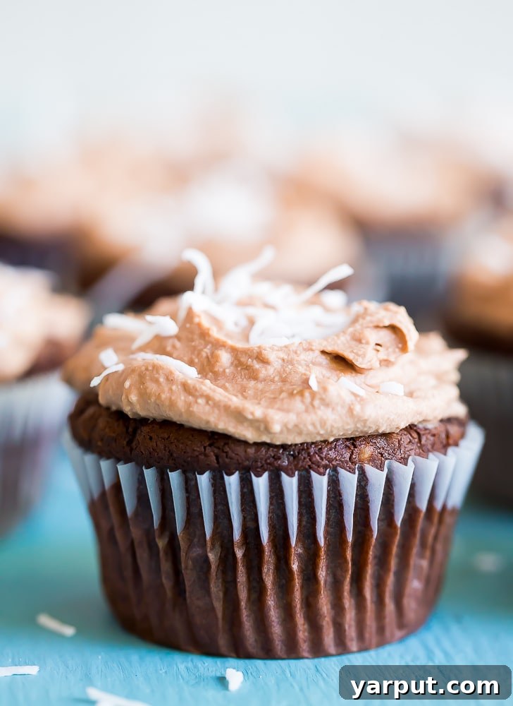 Decadent Vegan Gluten-Free Chocolate Coconut Cupcakes with Silky Chocolate Whipped Cream 8 A vibrant display of Chocolate Coconut Cupcakes, beautifully garnished and ready to be enjoyed by all.