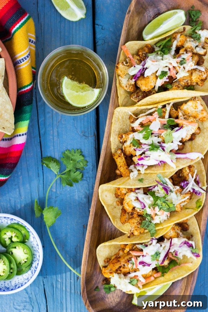 Guilt-Free Mexican Delights 6 Flavorful BBQ Cauliflower and Chickpea Tacos served with a creamy lime slaw.