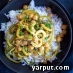 A beautifully presented bowl of Orange Ginger Zucchini Noodle & Chickpea Bowls