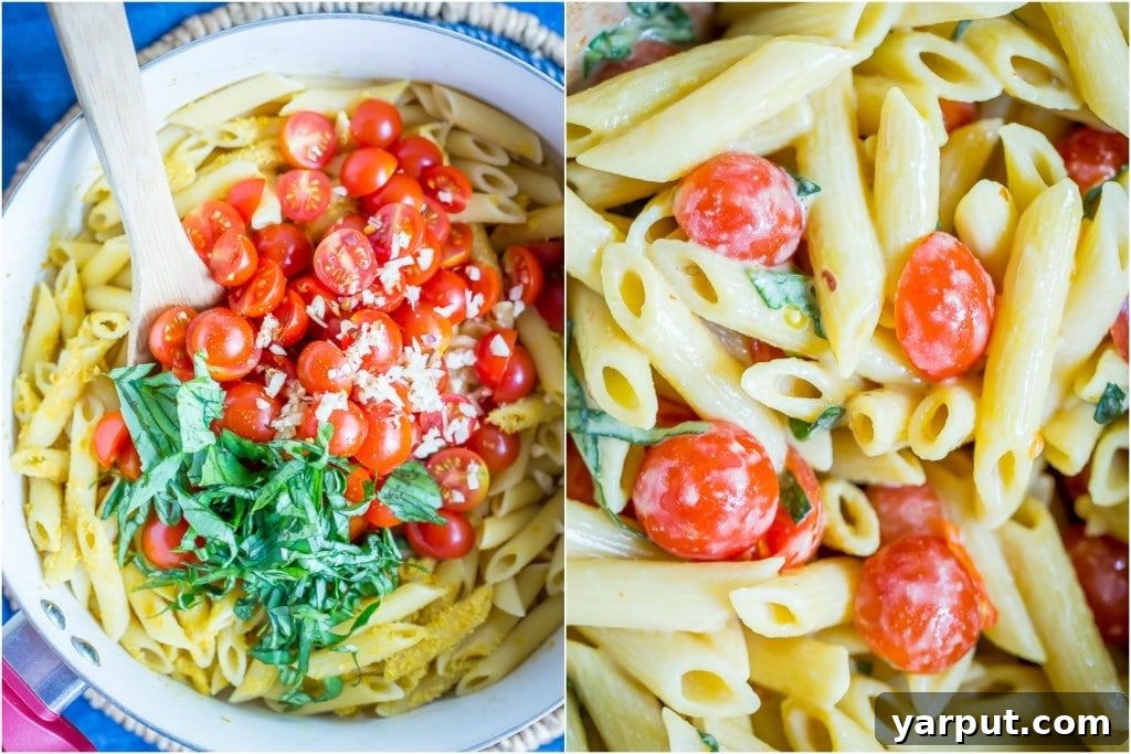 Close-up of One-Pot Creamy Vegan Caprese Pasta showcasing the rich sauce, pasta, and halved cherry tomatoes.