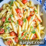 One-Pot Creamy Vegan Caprese Pasta with fresh cherry tomatoes and basil, perfect for a quick and healthy summer dinner.