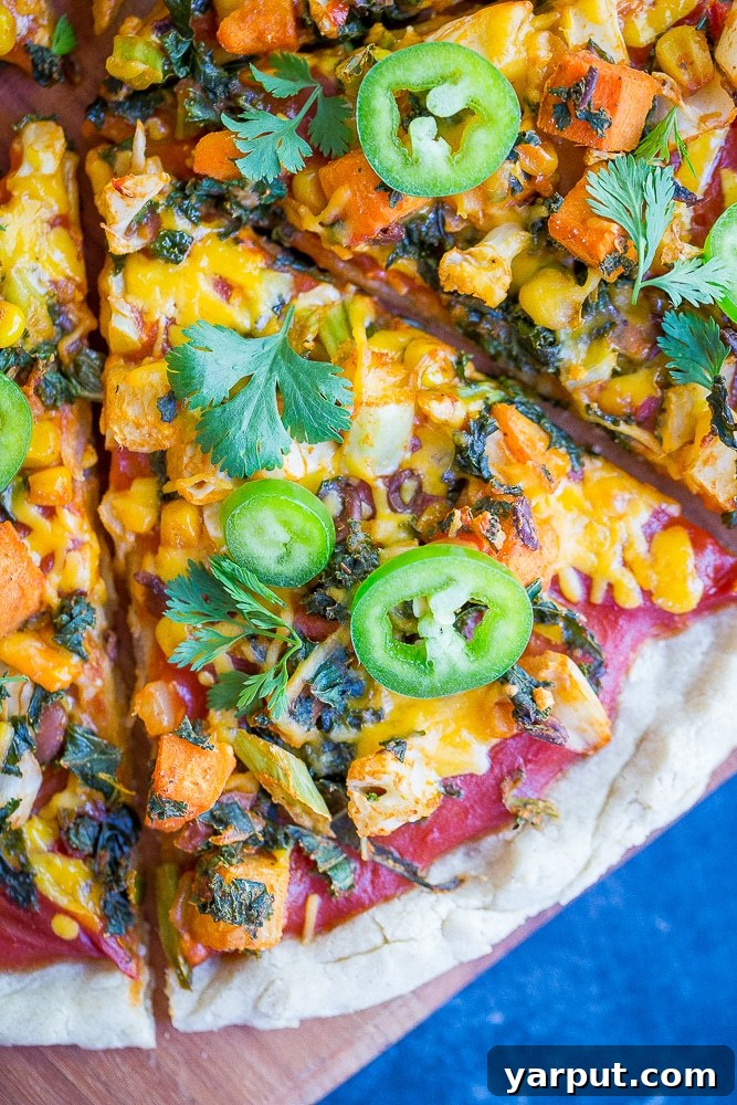 Southwest Fiesta Pizza 5 Freshly baked Southwest Veggie Taco Pizza with melted cheese and vibrant toppings, ready to be sliced.