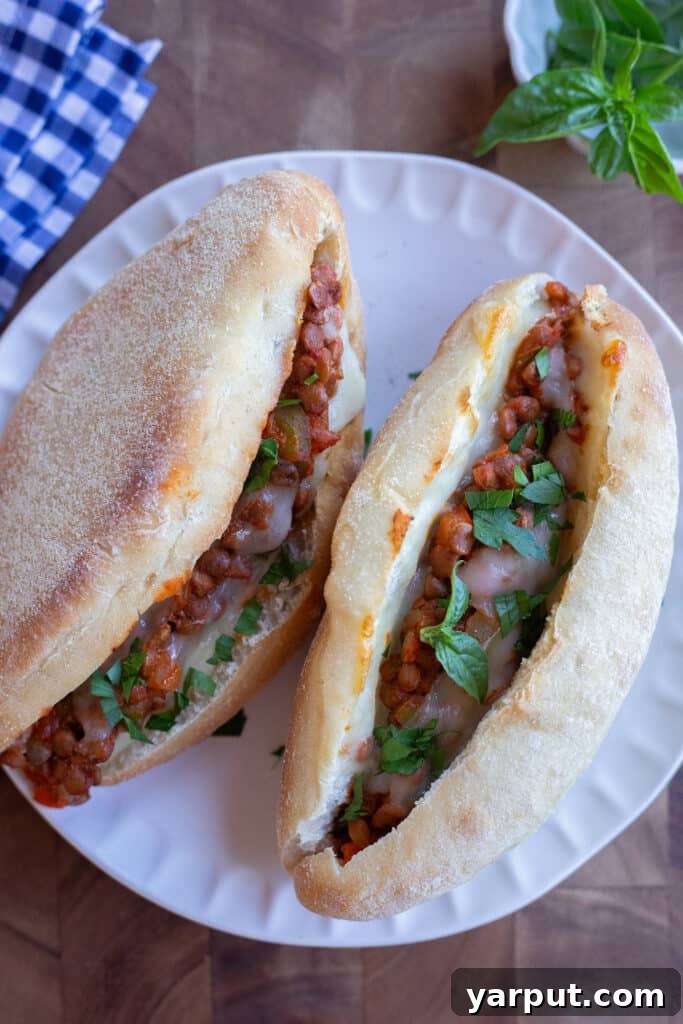 Hearty Lentil Meatball Subs with Savory Marinara 6 Plate with two cooked meaty lentil subs