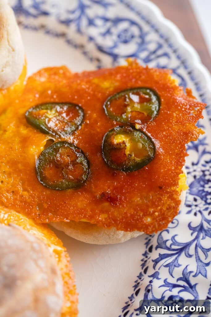close up of the crispy cheese and jalapeños on top of the egg