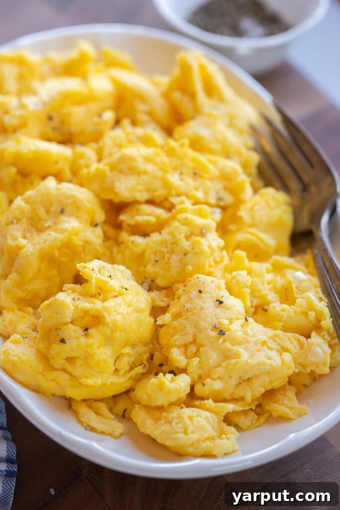 Close up of fluffy scrambled eggs on a serving platter