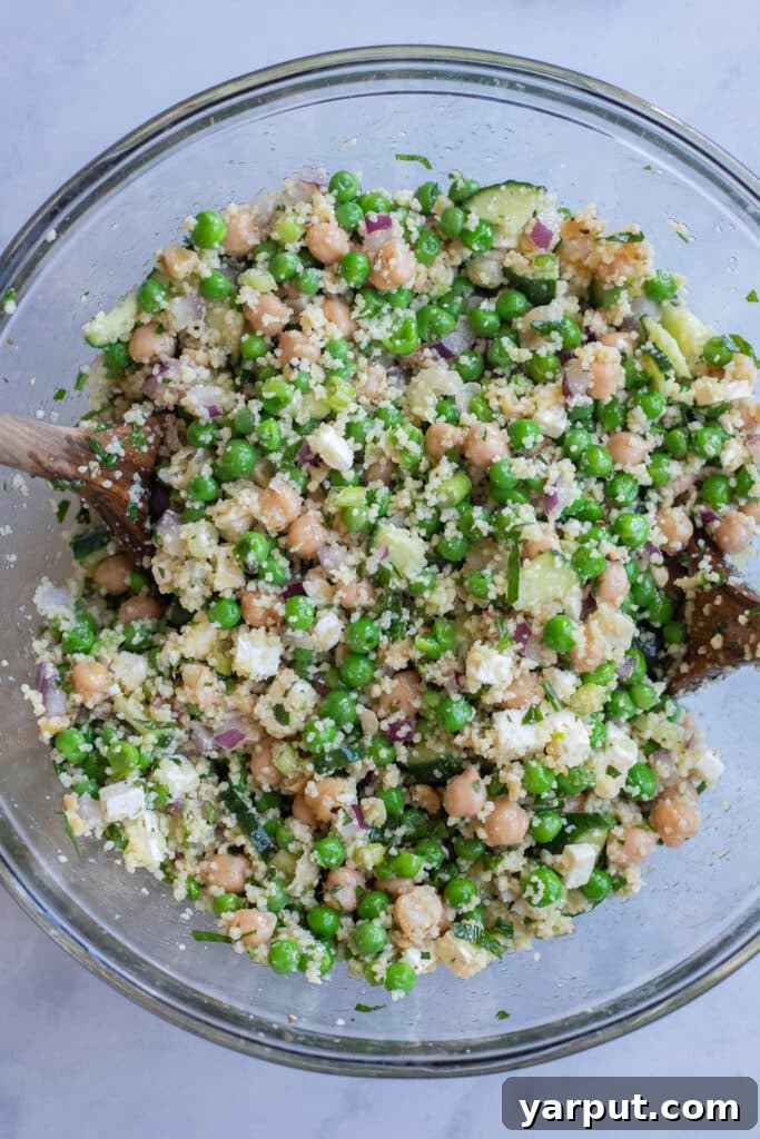 sweet pea and couscous salad all mixed together in a bowl