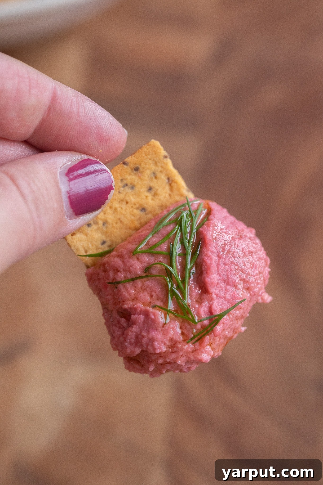 Pickled Beet Hummus Recipe: A Vibrant Twist on Classic 7 close up of a cracker topped with beet hummus