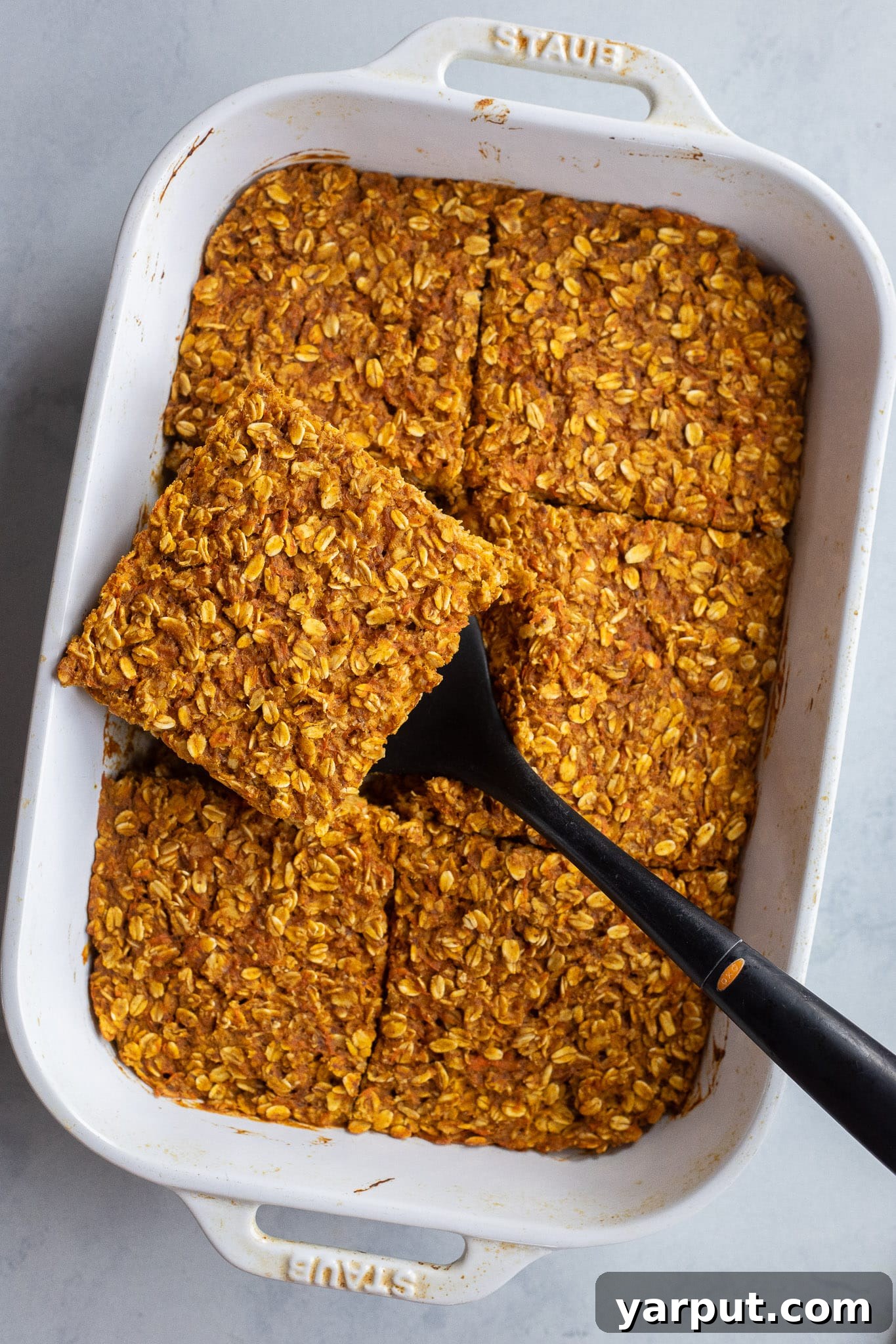 Warm Pumpkin, Ginger & Turmeric Baked Oatmeal 6 slice of pumpkin carrot baked oatmeal in a pan